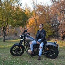 Photo of Liliana "Patty" Flores sitting on a motorcycle.