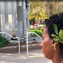 Brandi Taylor in front of iconic metallic UCR sign.