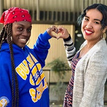Guardian Scholars students forming a heart with their hands.
