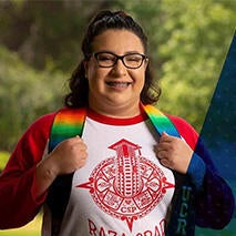 Smiling Monique Guerra in Raza graduation stole.
